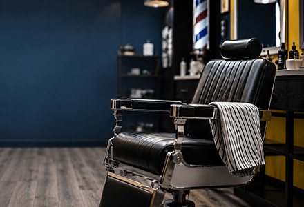 Image of a barber chair in a dark barber shop
