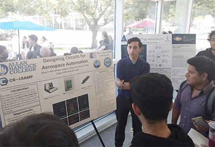 Student stands in front of presentation