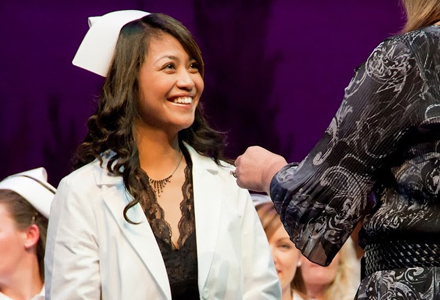 Woman getting a nursing pin