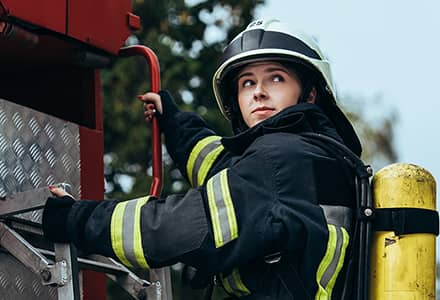 firefighter climbing a truck