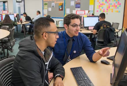 man helping student