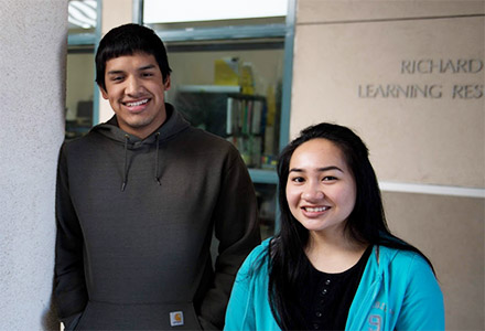 Male and female student smiling